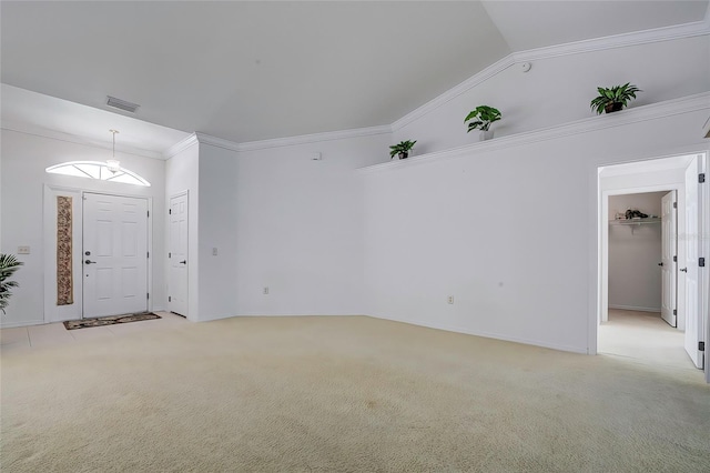 interior space featuring light colored carpet, lofted ceiling, and ornamental molding