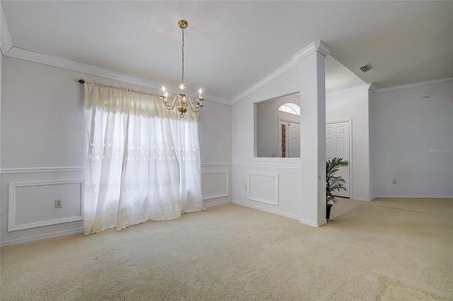 spare room featuring a chandelier, vaulted ceiling, light colored carpet, and ornamental molding