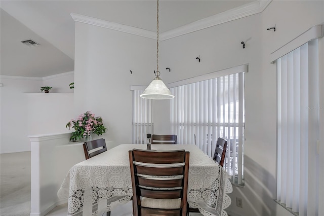 carpeted dining area with ornamental molding