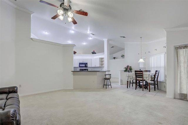 carpeted living room featuring ceiling fan, lofted ceiling, and ornamental molding