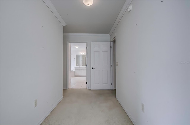 hall with light carpet and ornamental molding