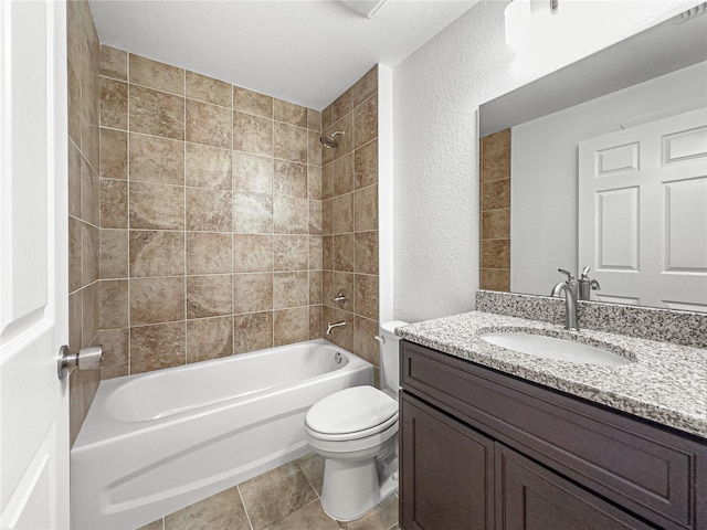 full bathroom with a textured ceiling, vanity, tile patterned floors, toilet, and tiled shower / bath combo