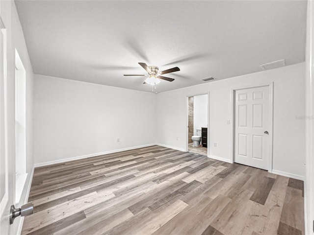 unfurnished room with light hardwood / wood-style floors, ceiling fan, and a textured ceiling