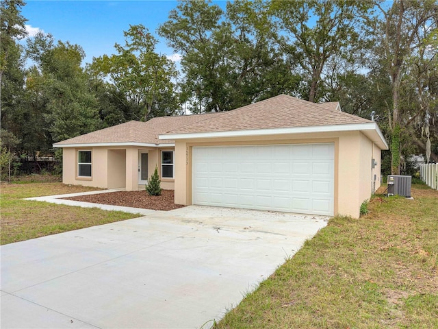 ranch-style home with central AC unit, a front yard, and a garage