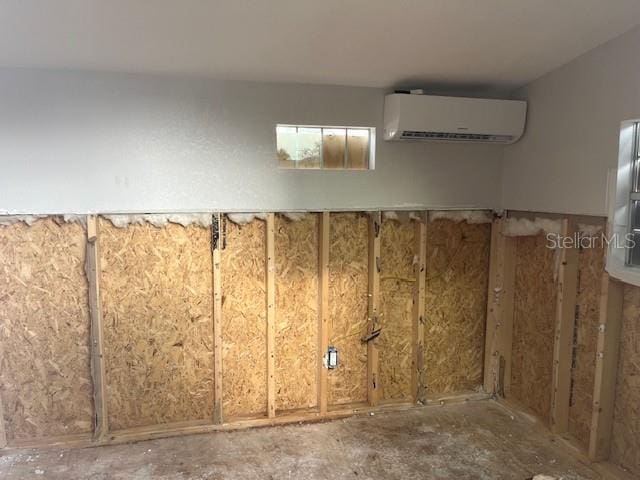 basement featuring a wall mounted air conditioner