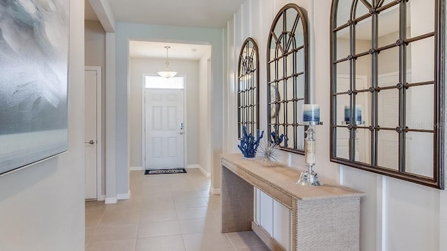 doorway to outside with light tile patterned floors