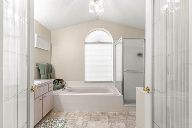 bathroom featuring vanity, separate shower and tub, and vaulted ceiling