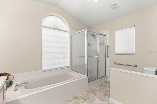 full bathroom with vanity, a healthy amount of sunlight, plus walk in shower, and vaulted ceiling