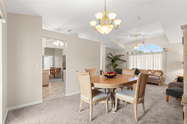 carpeted dining room featuring ceiling fan with notable chandelier