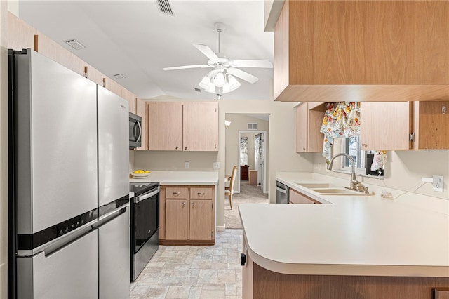 kitchen with stainless steel appliances, light brown cabinetry, sink, and kitchen peninsula