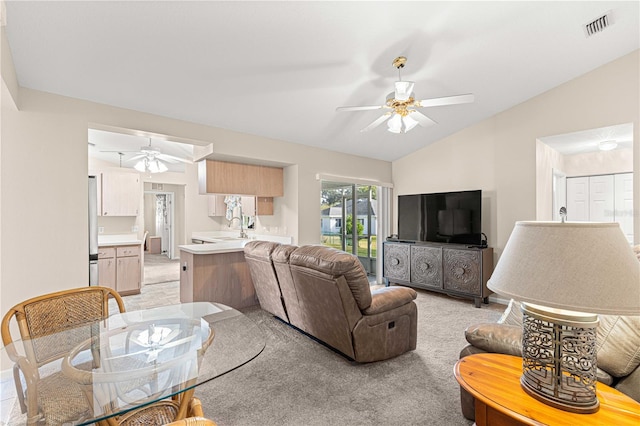 living room featuring ceiling fan, light colored carpet, sink, and lofted ceiling