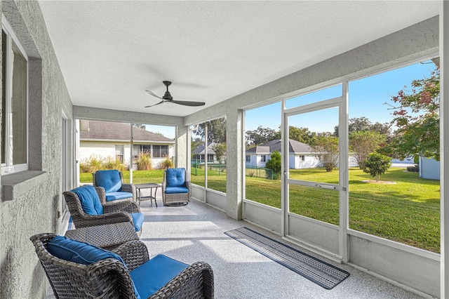 sunroom / solarium featuring ceiling fan