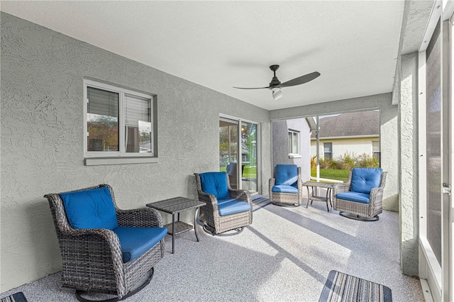 sunroom / solarium featuring ceiling fan