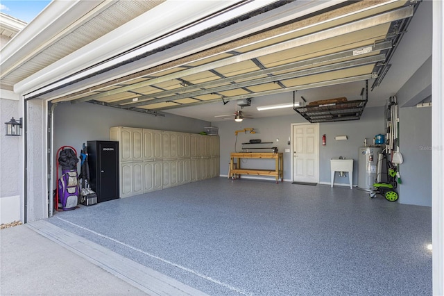 garage with a garage door opener, sink, electric water heater, and ceiling fan