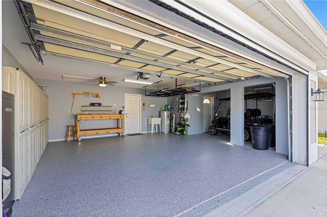 garage with water heater and a garage door opener