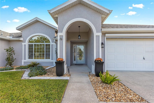 doorway to property featuring a lawn and a garage