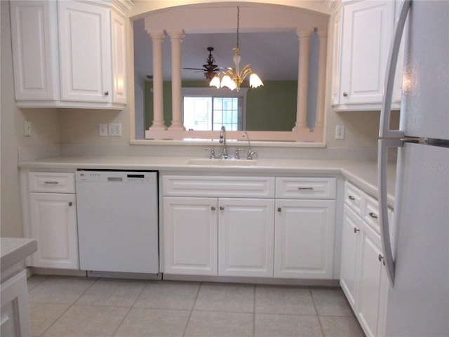 kitchen with sink, ceiling fan, light tile patterned floors, white appliances, and white cabinets