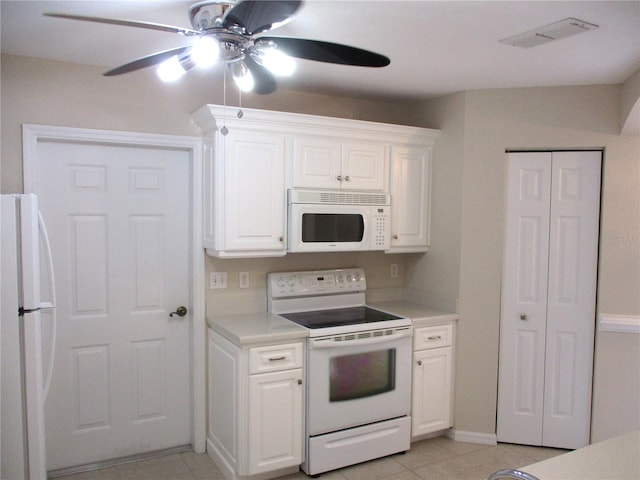 kitchen with white cabinets, light tile patterned floors, white appliances, and ceiling fan