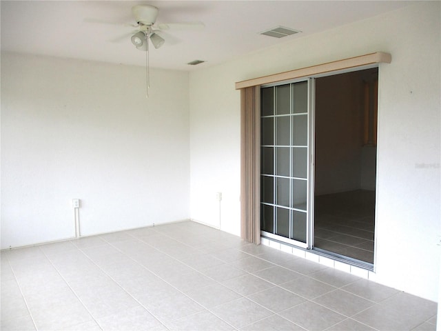 empty room featuring light tile patterned flooring and ceiling fan