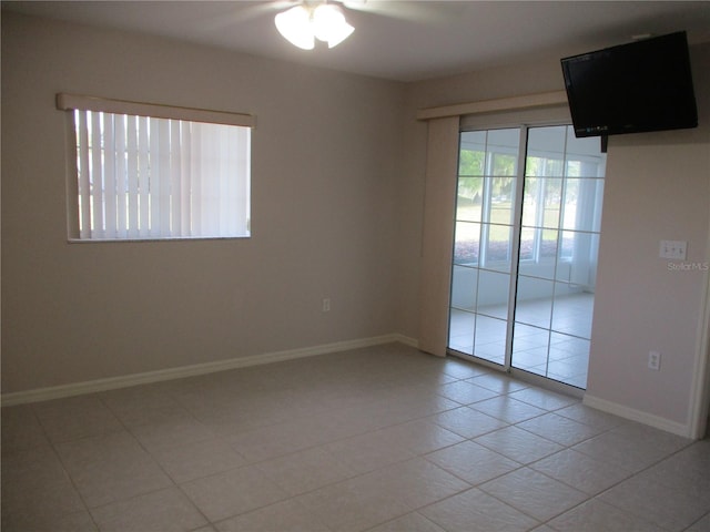 unfurnished room with light tile patterned flooring and ceiling fan