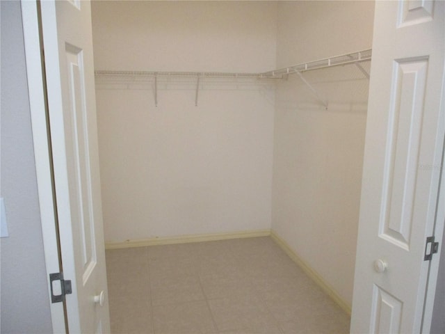 walk in closet featuring tile patterned flooring