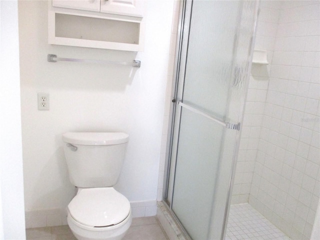 bathroom with toilet, an enclosed shower, and tile patterned floors