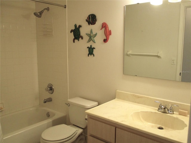 full bathroom featuring toilet, tiled shower / bath combo, and vanity