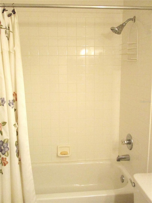 bathroom with toilet and shower / tub combo