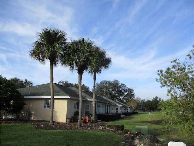 view of property exterior with a yard