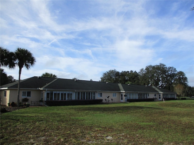 rear view of house with a yard