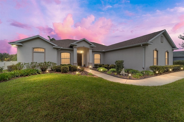 single story home featuring a yard