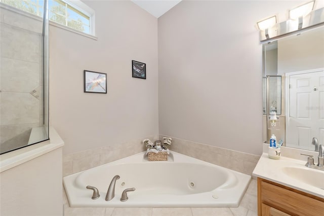 bathroom featuring vanity and a relaxing tiled tub