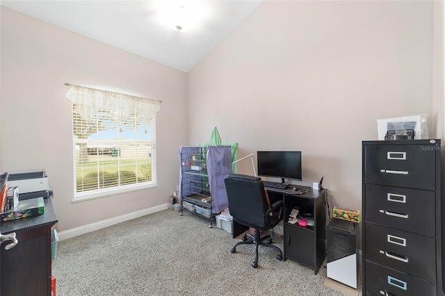 carpeted office featuring lofted ceiling