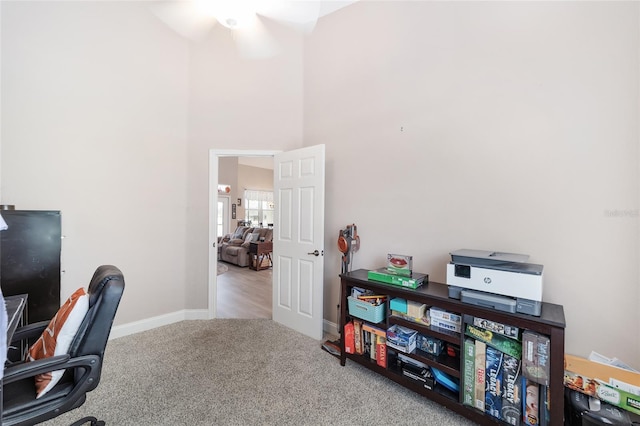 carpeted home office with ceiling fan