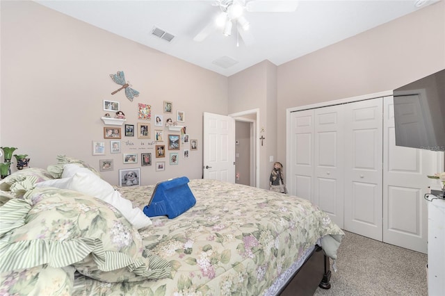 bedroom with ceiling fan, carpet flooring, and a closet