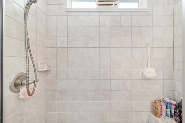 bathroom featuring plenty of natural light and a tile shower