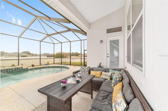 view of pool featuring glass enclosure, a patio, and an outdoor living space