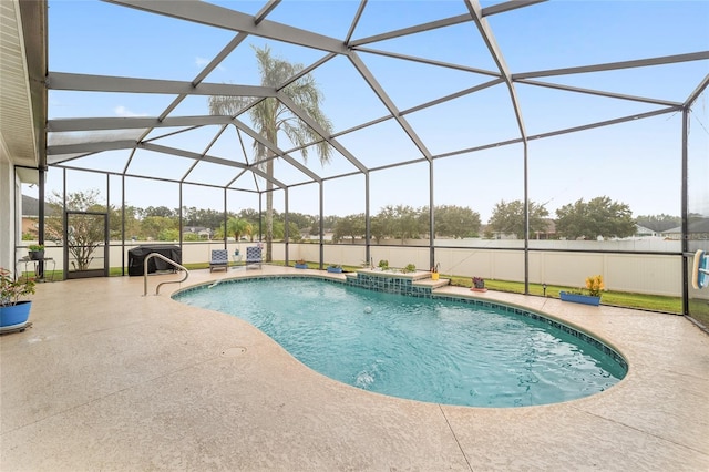 view of swimming pool featuring glass enclosure and a patio