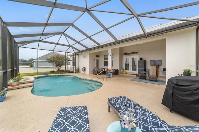 view of pool featuring a lanai, a patio, and french doors