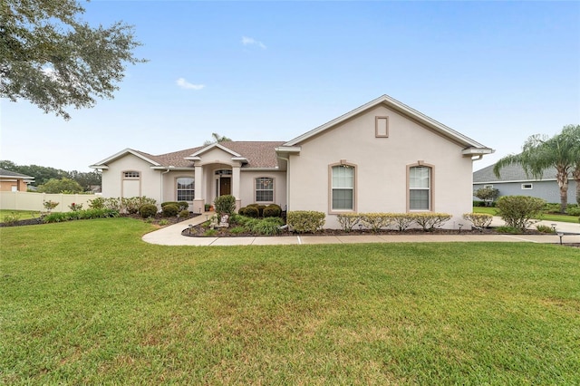 single story home featuring a front lawn