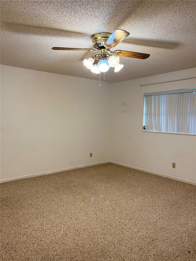 carpeted spare room featuring a textured ceiling and ceiling fan