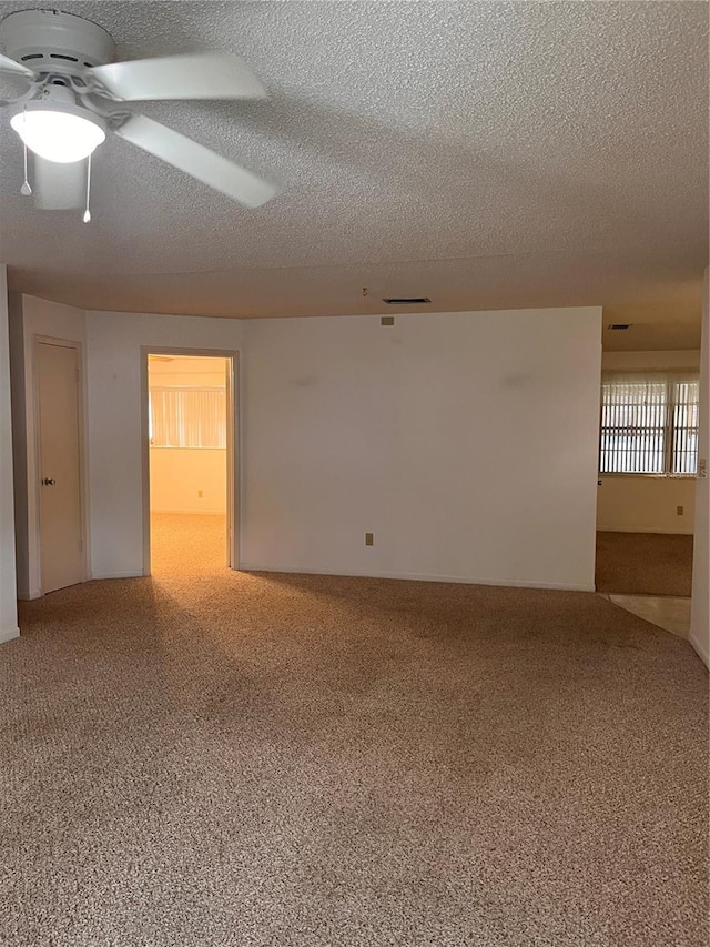 unfurnished room featuring ceiling fan and a textured ceiling