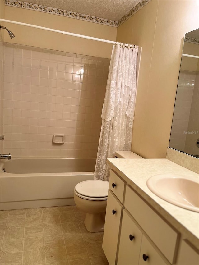 full bathroom featuring toilet, shower / bath combination with curtain, vanity, and a textured ceiling