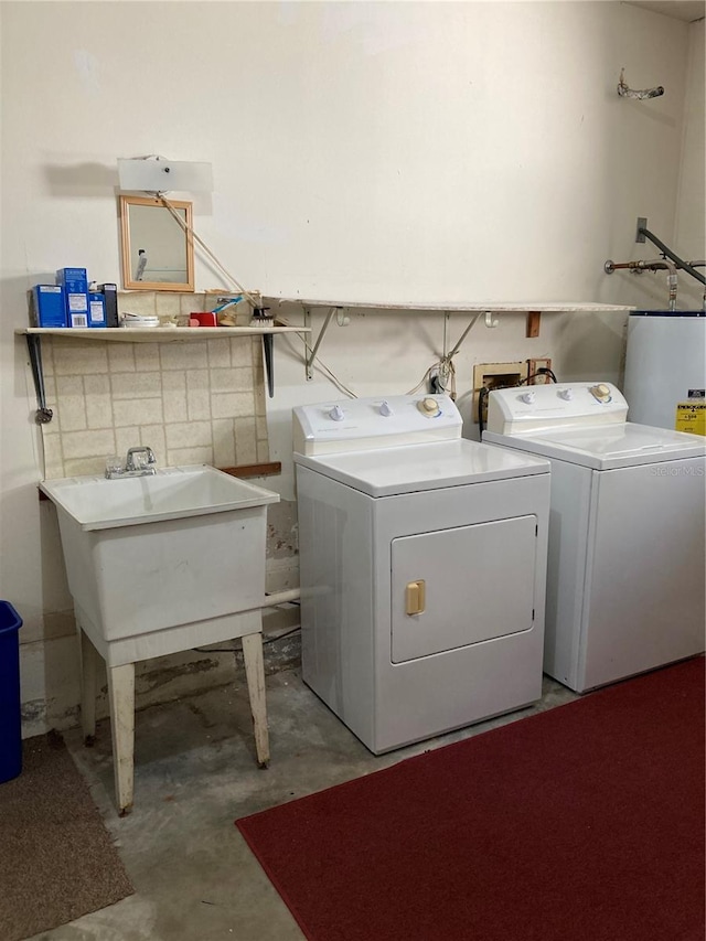 laundry room featuring water heater, sink, and washer and dryer