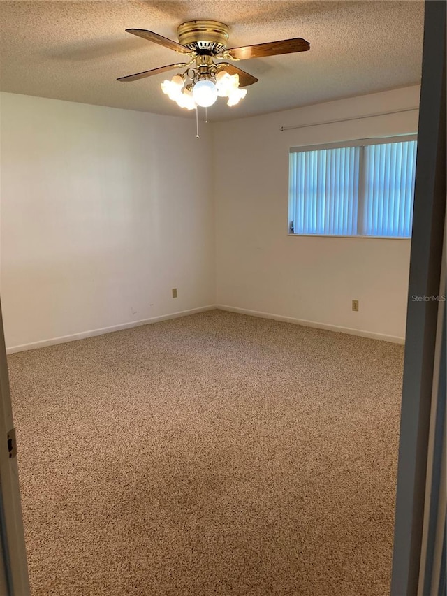 carpeted empty room with a textured ceiling and ceiling fan