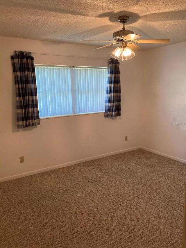 unfurnished room with ceiling fan, a textured ceiling, and carpet floors