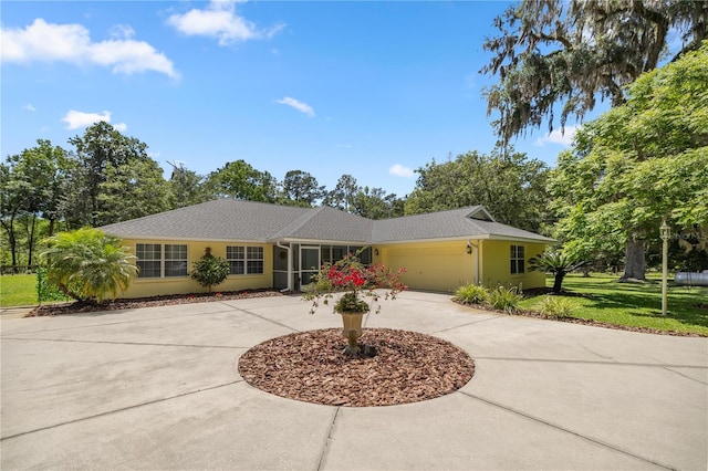 single story home with a garage and a front yard