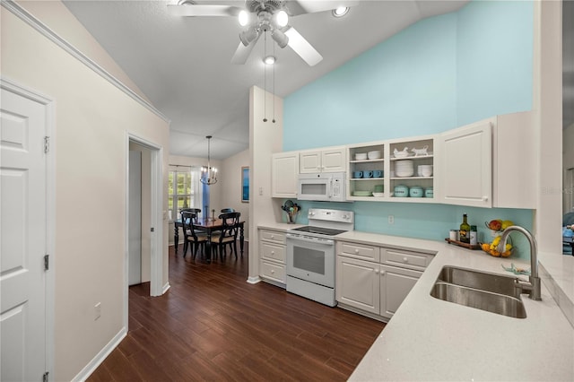 kitchen featuring dark hardwood / wood-style flooring, white cabinets, sink, white appliances, and decorative light fixtures