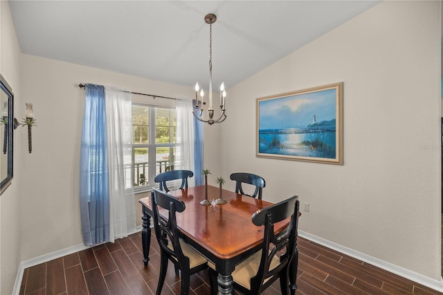 dining room featuring lofted ceiling, an inviting chandelier, and dark hardwood / wood-style floors