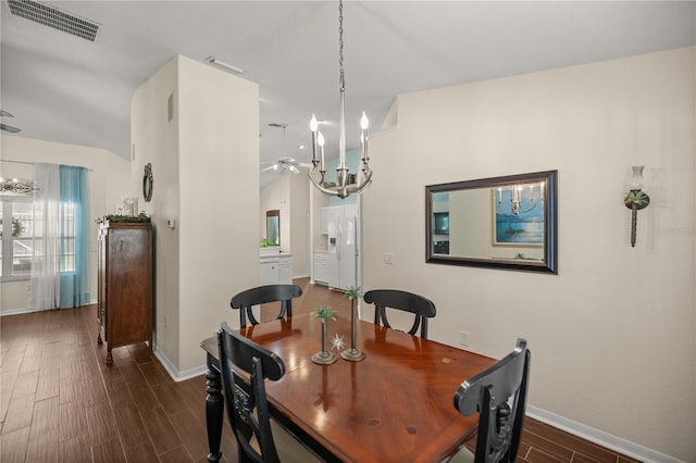 dining room featuring dark wood-type flooring and ceiling fan with notable chandelier